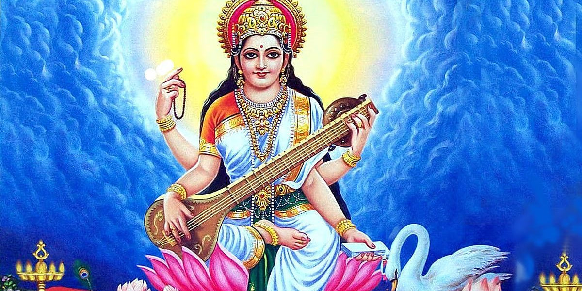 Goddess Saraswati in white and blue seated on a pink lotus playing the veena beside a white swan - Divine Sansar