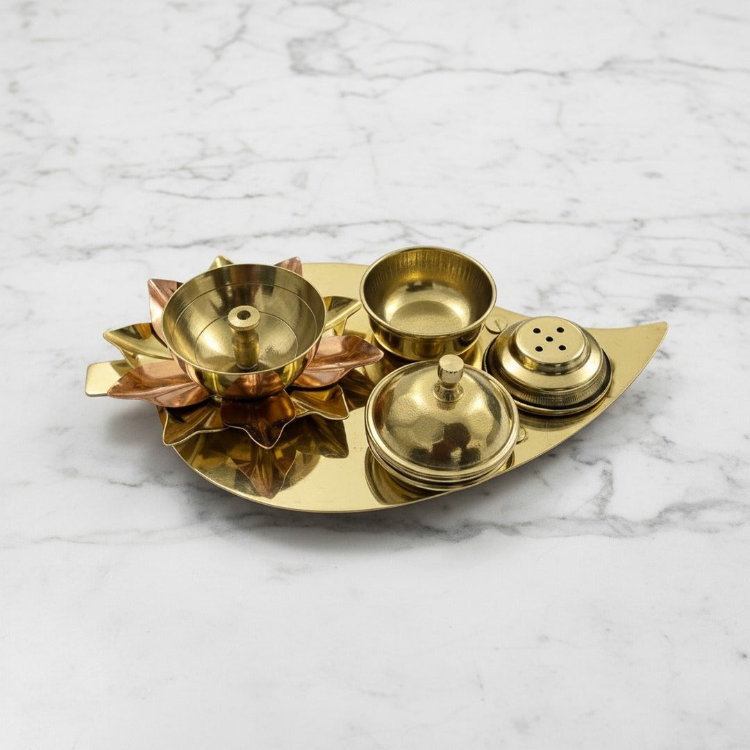 Brass lotus diya with kumkum box, katori and agarbatti stand on a leaf tray - Divine Sansar