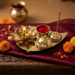 Lit brass lotus diya with kumkum and agarbatti on a home mandir in the UAE - Divine Sansar