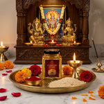 Chandan kesar powder jar on a brass pooja thali before a home mandir with diya and roses - Divine Sansar UAE