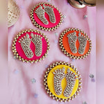 Kundan Laxmi charan discs in pink, orange and yellow on festive fabric - Divine Sansar
