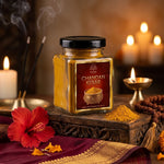 Chandan kesar tilak powder beside a lit brass diya and rudraksha mala - Divine Sansar