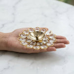 Small crystal brass diya resting on an open palm to show its size - Divine Sansar