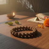 Rudraksha bracelet with diya and marigold for daily puja and meditation - Divine Sansar
