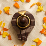 Narmadeshwar Shivling stone peetham top view yoni base with marigold - Divine Sansar