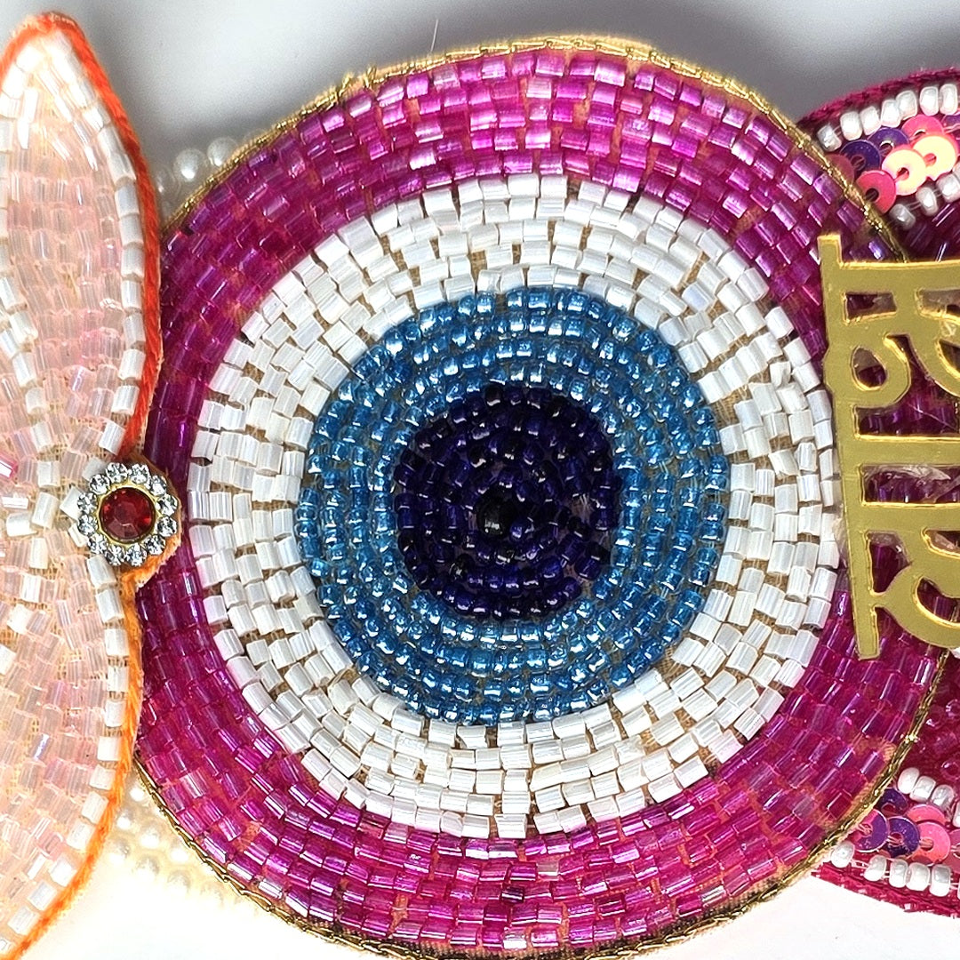 Nazar eye beadwork detail in magenta, white, turquoise and navy on the Divine Sansar Shubh Labh hanging