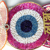 Nazar eye beadwork detail in magenta, white, turquoise and navy on the Divine Sansar Shubh Labh hanging