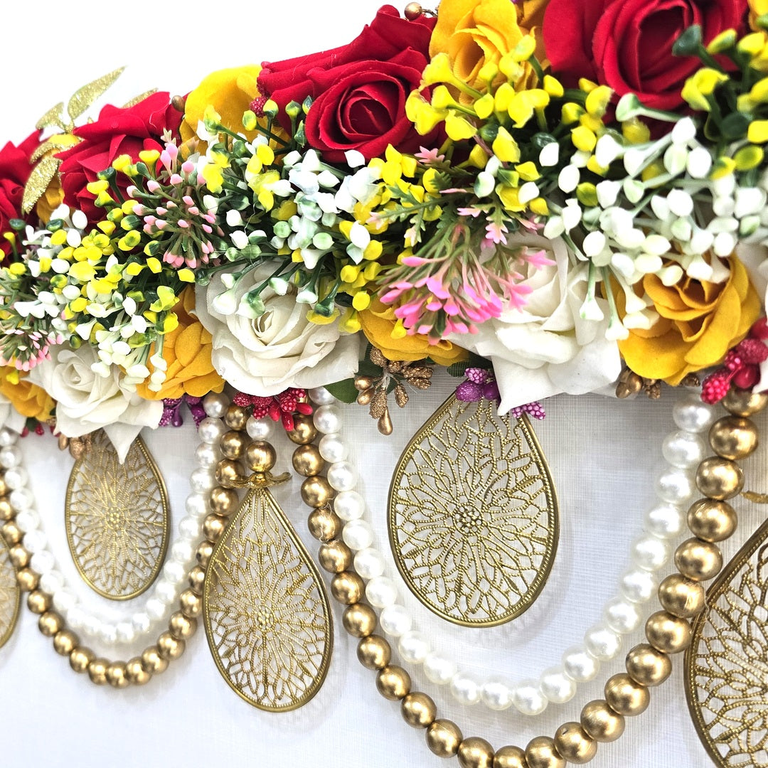 Gold jali teardrop and pearl bead swag detail on the Divine Sansar rose toran