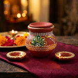Karwa Chauth pooja setup with hand-painted clay karwa and lit diyas - Divine Sansar