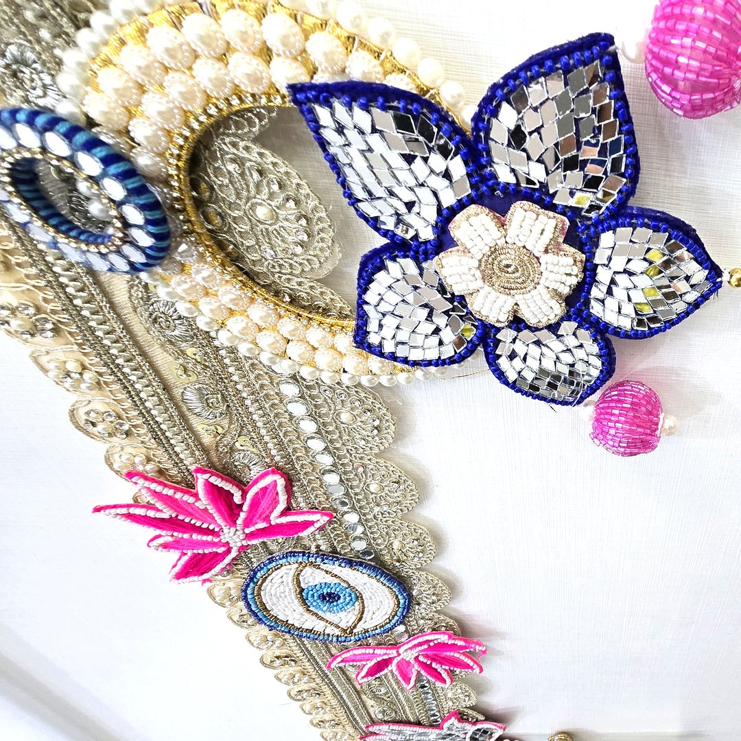 Corner beadwork with pearl ring and pink beaded bells on the Divine Sansar bandhanwar