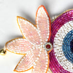 Pale pink beaded lotus crown with red stone on the Divine Sansar evil eye Shubh Labh hanging