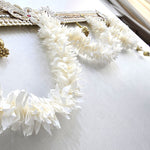 Close-up of the fabric mogra garland swag on the Divine Sansar door toran