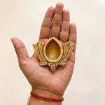 Brass Kamal Diya in the palm of a hand showing its 6 cm size - Divine Sansar