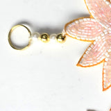 Brass ring hanger with pearl and gold beads on the Divine Sansar pink evil eye Shubh Labh hanging