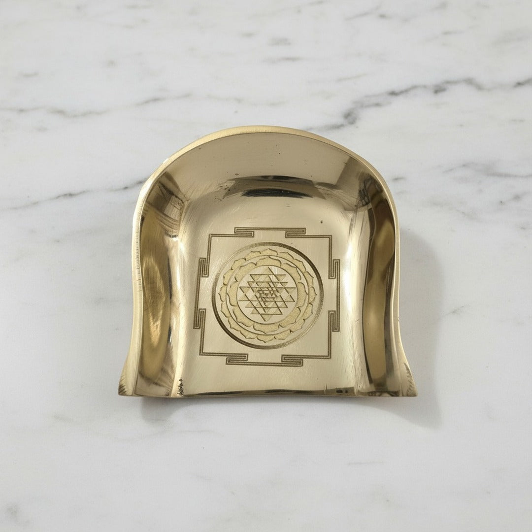 Brass Shree Yantra soop murum on white marble, engraving close up - Divine Sansar