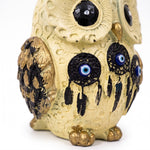 Close up of nazar evil eye beads on owl statue - Divine Sansar