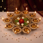 Diwali urli with ten lit diyas and floating flowers on a festive table in the UAE, Divine Sansar