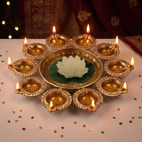 Lit 10 diya urli with a white floating lotus in the centre bowl for Diwali, Divine Sansar
