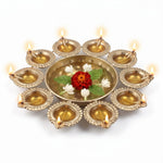 10 diya urli with all ten diyas lit and marigold floating in water, Divine Sansar