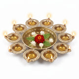 10 diya urli with all ten diyas lit and marigold floating in water, Divine Sansar