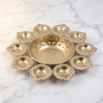 Brass finish 10 diya urli bowl on white marble, Divine Sansar