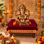 Maroon velvet pooja aasan on a chowki under Ganesh idol in a home mandir - Divine Sansar
