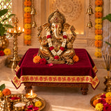 Maroon velvet pooja aasan on a chowki under Ganesh idol in a home mandir - Divine Sansar