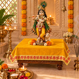 Yellow velvet pooja aasan on a chowki under Krishna idol in a home mandir - Divine Sansar