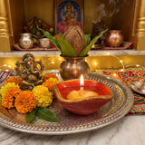 365 batti lit in a red and gold chaumukhi diya at a home mandir - Divine Sansar