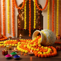 Divine Sansar-Decorative setup with orange and yellow flower garlands, candles, and small gift boxes on a wooden floor.