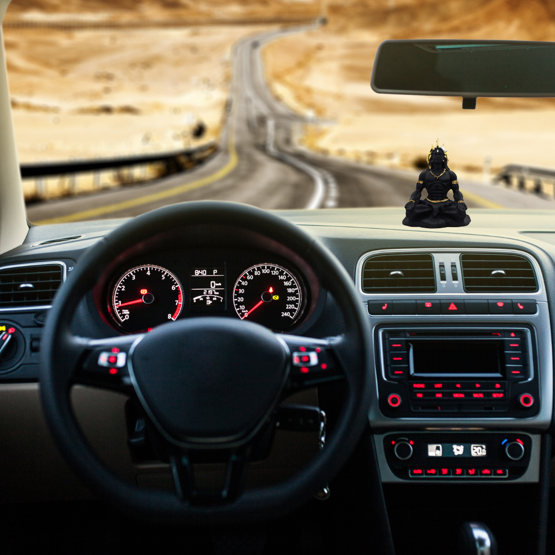 Divine Sansar-Black & Gold Lord Shiva Idol-Car interior with a dashboard view, steering wheel, and rearview mirror, with a Shiva statue