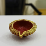 Divine Sansar-Clay Diya decorated with gold rim and red interior on a white surface