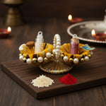 Kumkum Set on a Raksha Bandhan pooja table with diyas, Divine Sansar