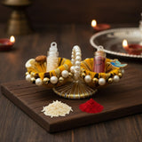 Kumkum Set on a Raksha Bandhan pooja table with diyas, Divine Sansar