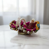 Pink kumkum tilak set on a marble table in a UAE home, Divine Sansar