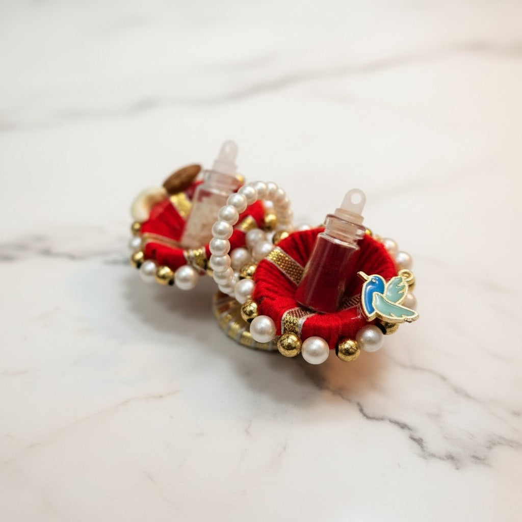 Red kumkum set with roli and akshat vials and bird charm, Divine Sansar