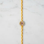 Pearl and gold sequin moti rakhi on marble - Divine Sansar UAE