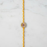 Pearl and gold sequin moti rakhi on marble - Divine Sansar UAE
