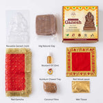 Make Your Own Ganesh Kit contents laid flat with labels - mould, natural clay, coconut fibre, mustard oil, red gamcha, red velvet aasan, kumkum chawal tray and wet tissue - Divine Sansar