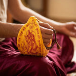 Hand chanting japa with rudraksha mala inside a Gomukhi bag - Divine Sansar UAE