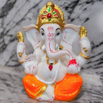 Divine Sansar Divine Ganesha Statue -White and Orange on a marble surface