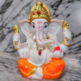 Divine Sansar Divine Ganesha Statue -White and Orange on a marble surface