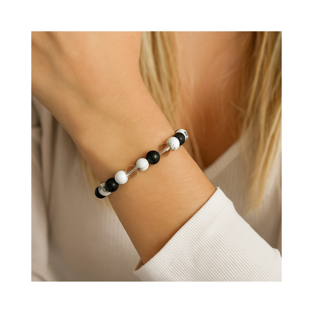 Divine Sansar-Crystal Energy Trinity Bracelet: Howlite · Clear Quartz · Lava-bracelet on a wrist with a neutral background