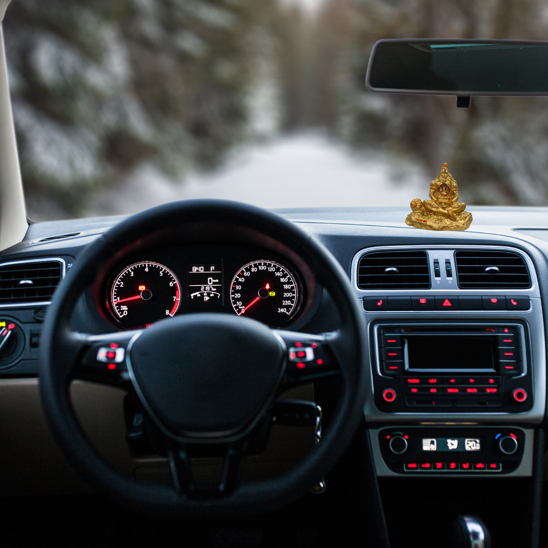 Divine Sansar-Golden Lord Hanuman Idol-Car interior with dashboard and steering wheel, featuring Golden Lord Hanuman Idol on the dashboard.