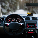 Divine Sansar-Hanumanji Gada-Car interior with dashboard and steering wheel, blurred road in the background