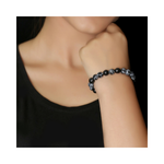 Divine Sansar-InnerPeace Bracelet-Snowflake Obsidian-Person wearing a InnerPeace Bracelet on a plain background