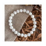 Divine Sansar-LunaGlow Bracelet-Moonstone bracelet on a textured brown surface