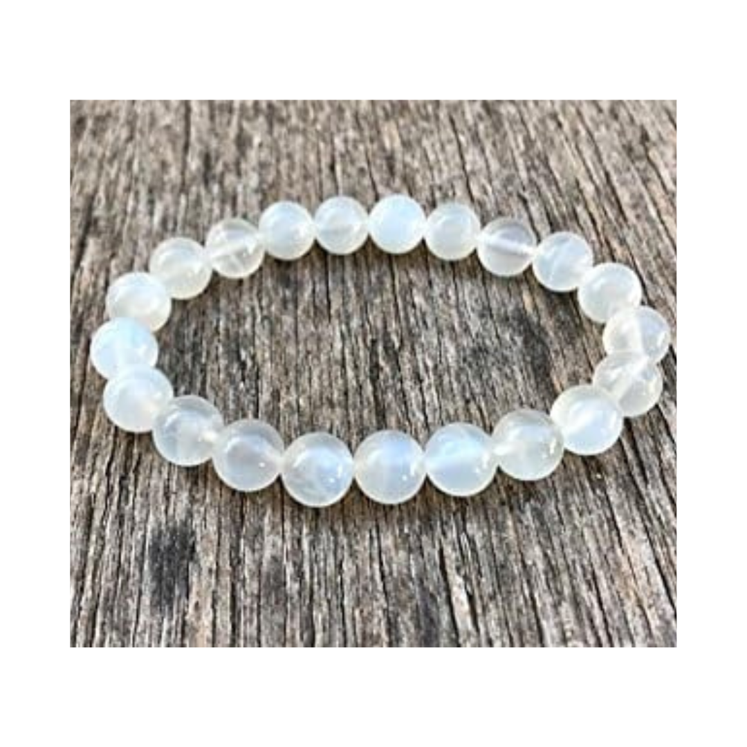 Divine Sansar-LunaGlow Bracelet-Moonstone bracelet on a wooden surface