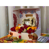 Divine Sansar-Mangal Bhawan : Personal Portable Temple-Decorative altar with flowers, candles, and religious items on a table.