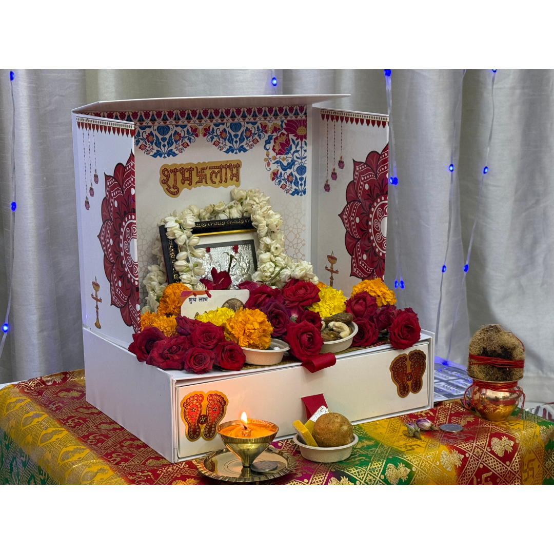 Divine Sansar-Mangal Bhawan : Personal Portable Temple-Decorative altar with flowers, candles, and religious items on a colorful tablecloth.